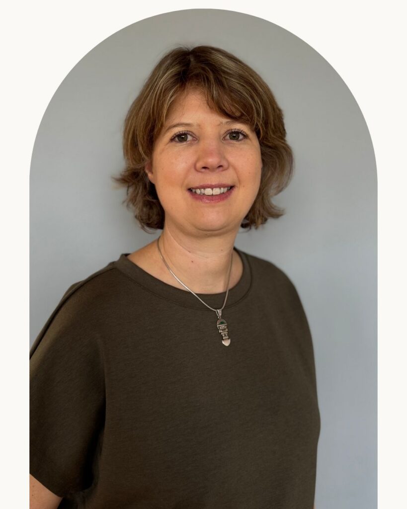 Portrait von Barbara Granzeuer, freundlich lächelnd vor neutralem Hintergrund.